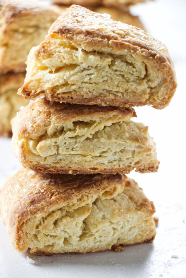 Three sour cream biscuits stacked on top of each other.