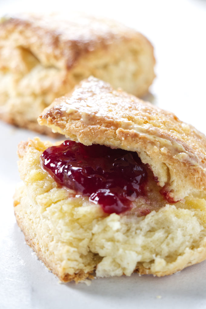 A sour cream biscuit with strawberry jam.