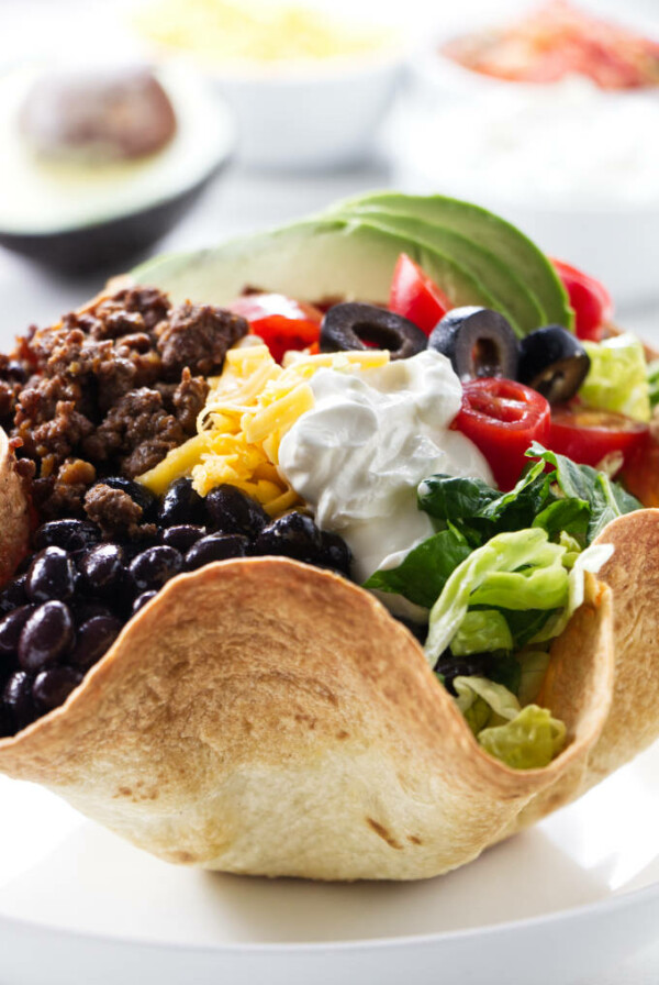 A beef taco salad in a tortilla bowl.