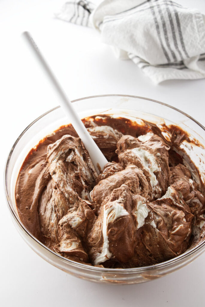 Bowl of chocolate/coffee mousse with whip cream being folded in