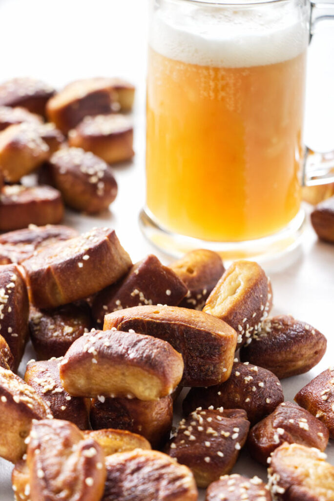 Pretzel bites with a glass of beer.