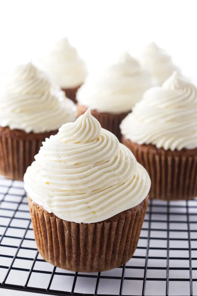 Cream cheese frosted carrot cake cupcakes on cooling rack