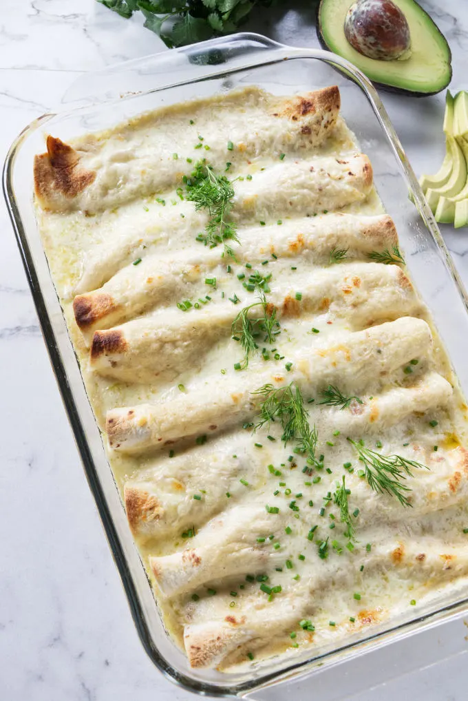 Freshly baked crab enchiladas in a baking dish.