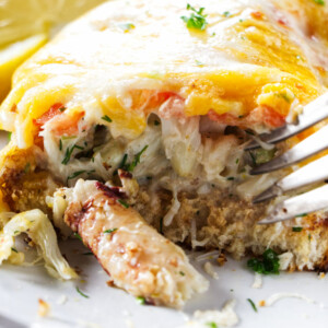 A fork scooping up the filling in a crab melt.