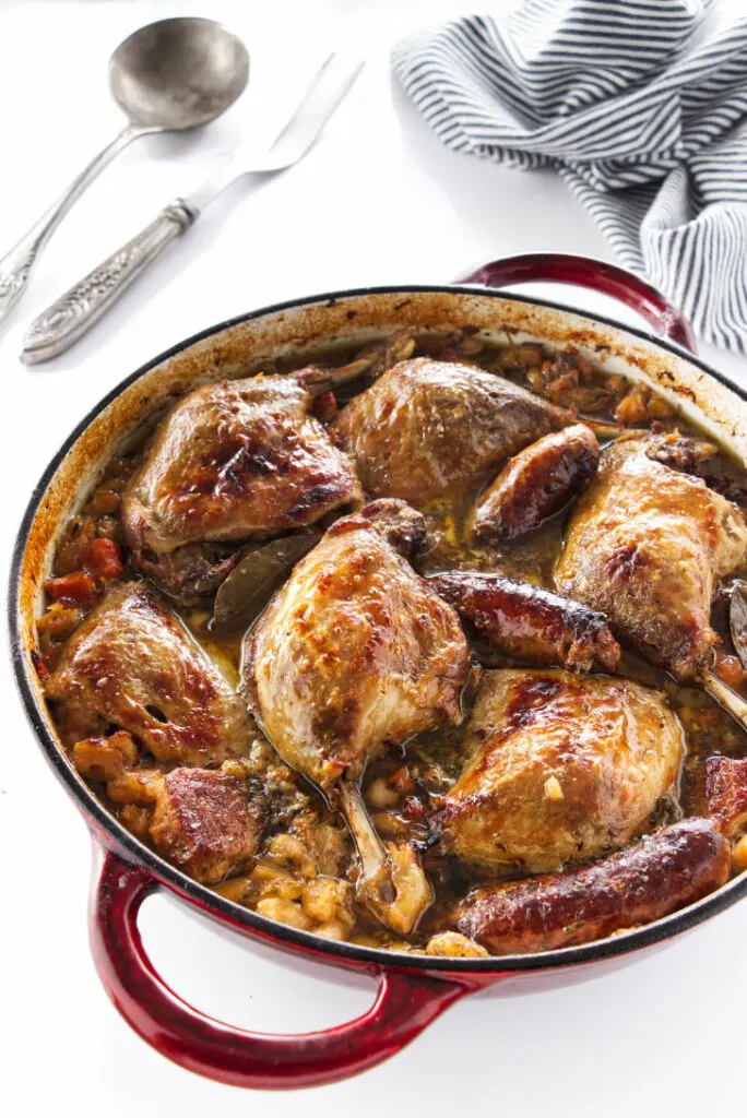 overhead view of cassoulet with duck legs, sausage and pork