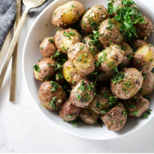 A serving dish with roasted baby potatoes.