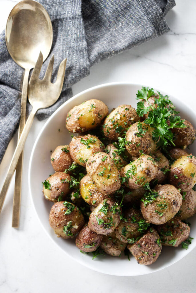 A serving dish with roasted baby potatoes.