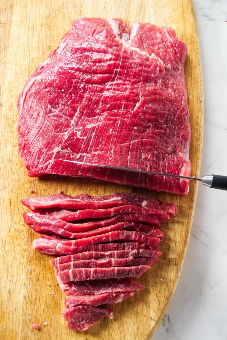 Slicing flank steak against the grain.