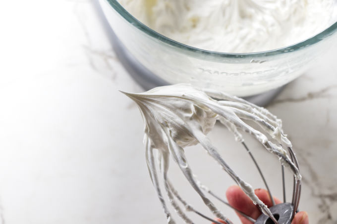 Whipped lard on a whisk after being whisked for several minutes.