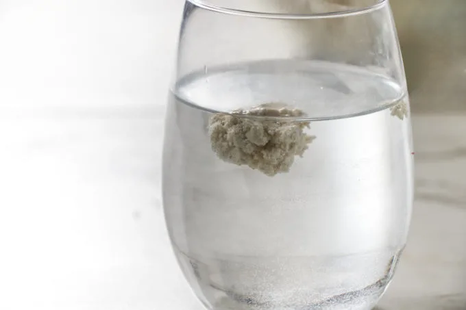 A small piece of masa dough floating in water.