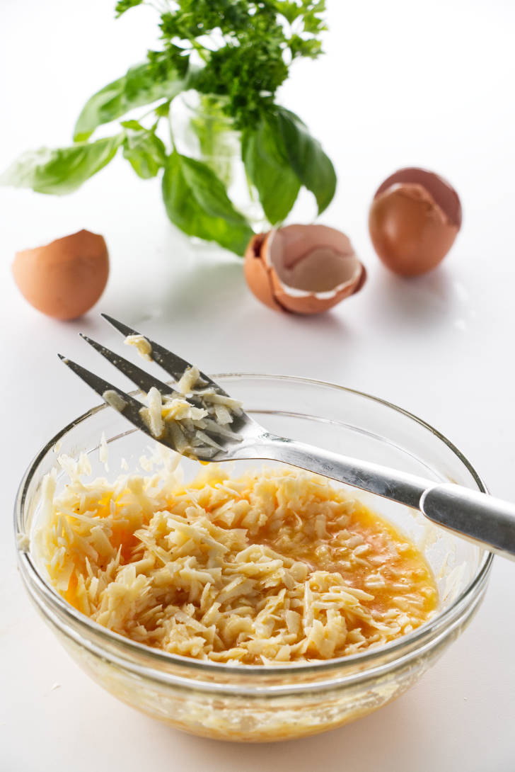 Mixing cheese and eggs for carbonara sauce.