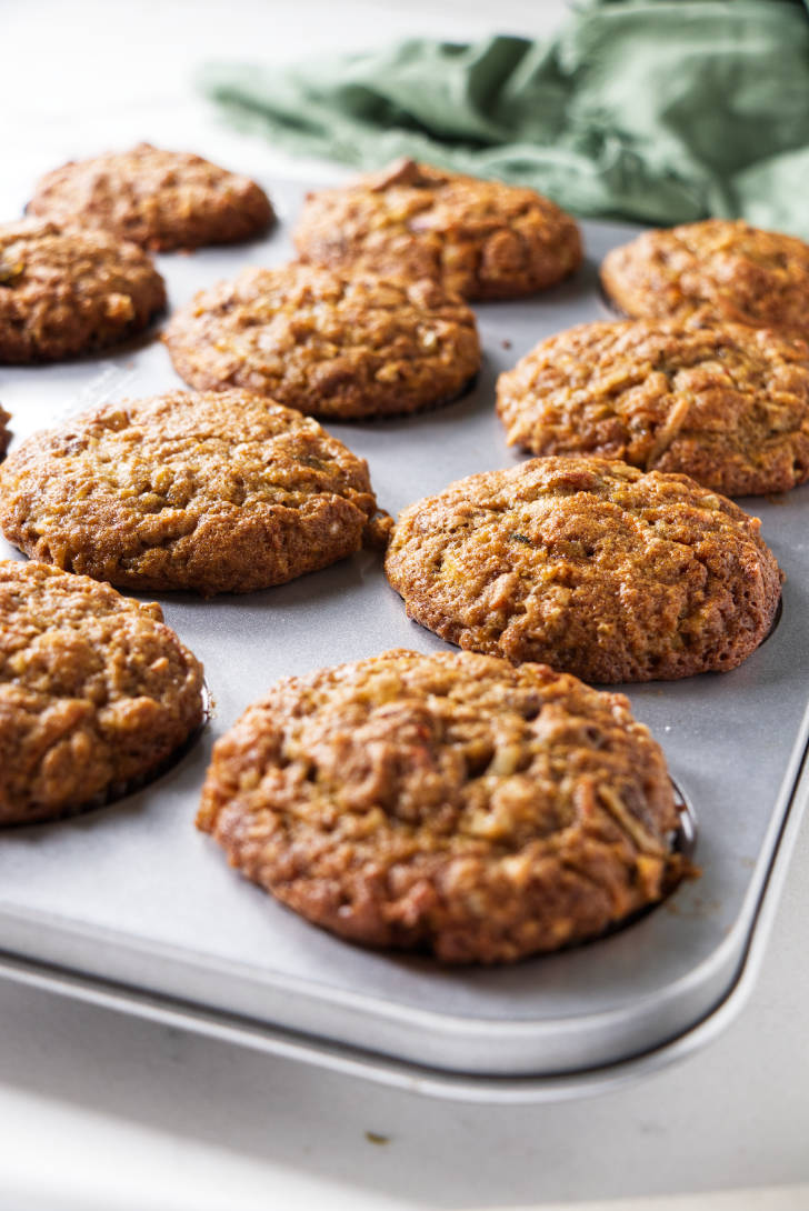 Carrot apple muffins in a muffin tin.