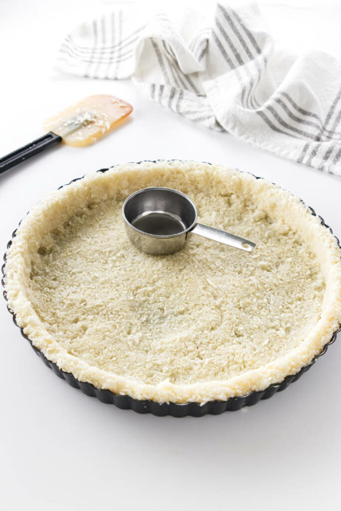 overhead view of coconut tart crust ready to bake