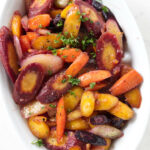 Glazed rainbow carrots in a serving dish.