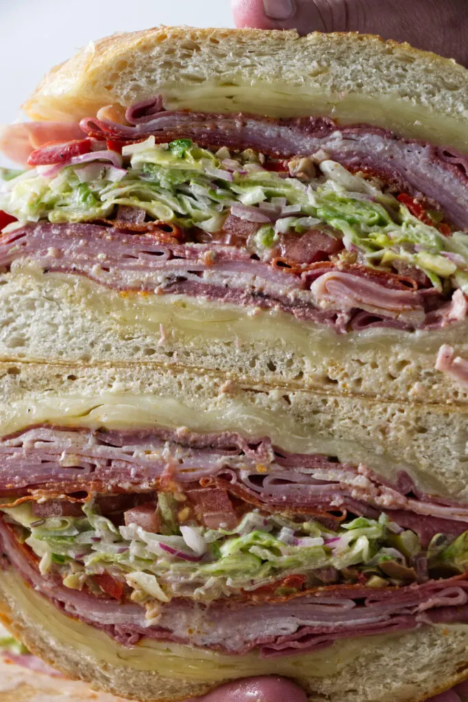 A sub sandwich sliced open to show the layers.