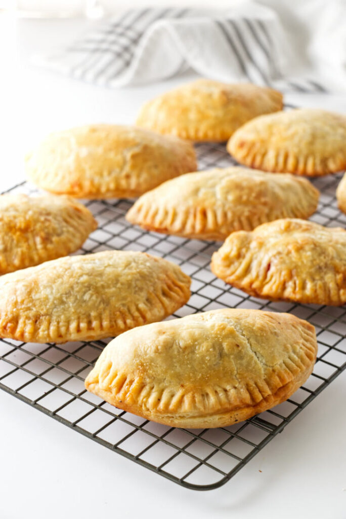 Baked Spanish chicken empanadas on a cooling rack