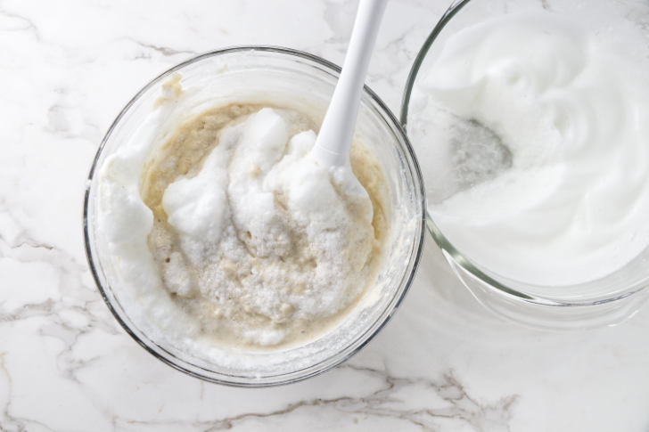 Folding egg whites into pancake batter.