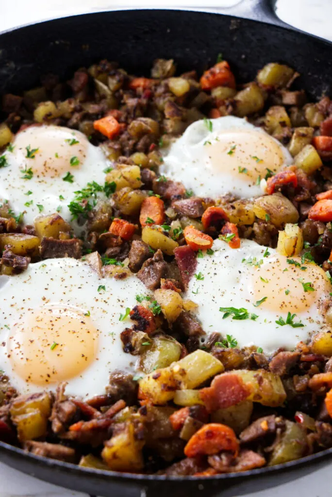 Beef hash with eggs nestled on top.