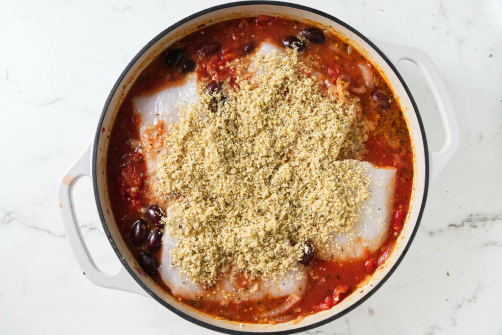 Topping halibut with bread crumbs.