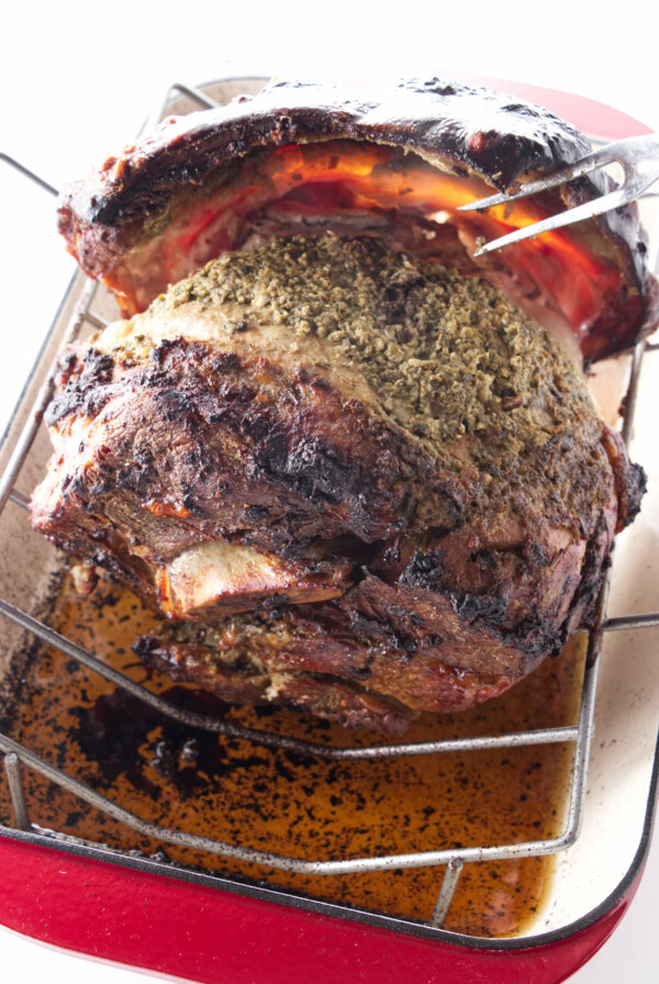 Lifting crispy skin off of a pork shoulder.