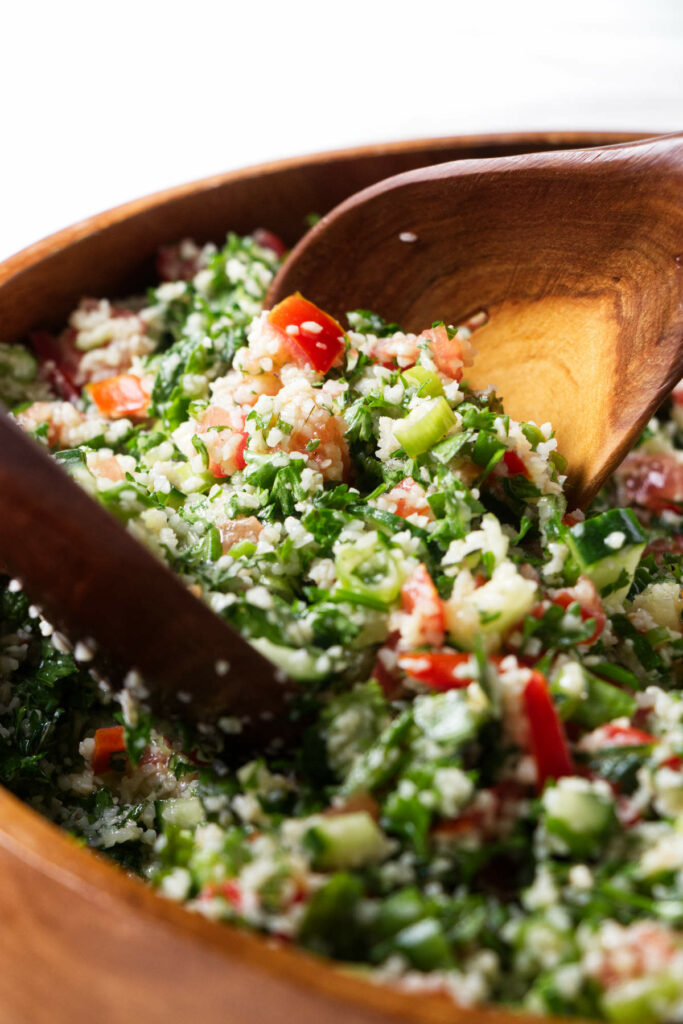 Mixing a tabbouleh salad.