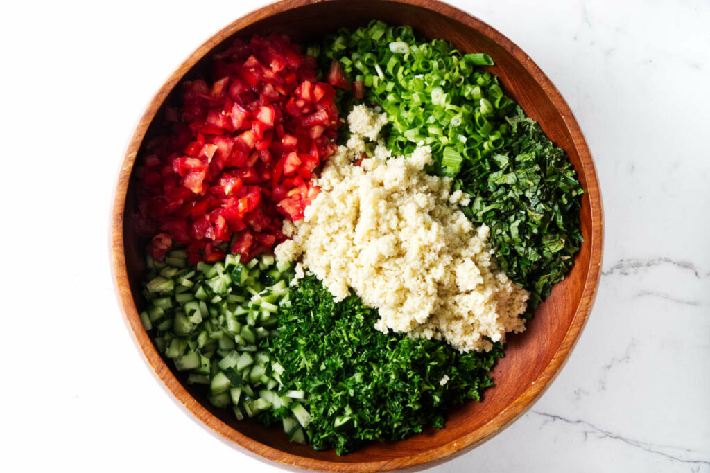 Combining the ingredients for an authentic tabbouleh salad.