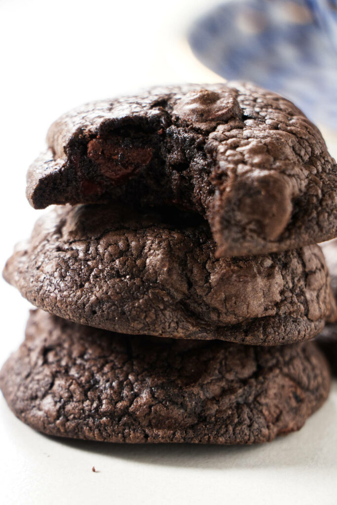 Three black cookies stacked on each other.