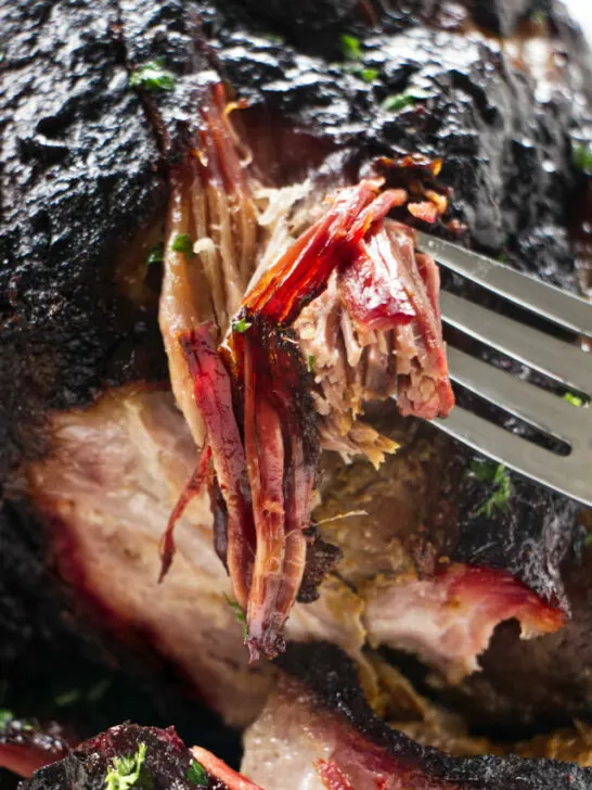 Shredding pulled pork to show the smoke ring.