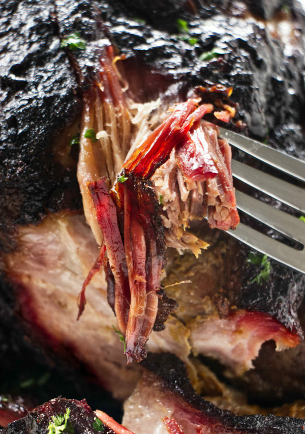 Shredding pulled pork to show the smoke ring.