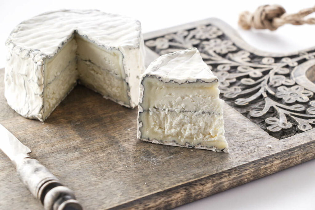 A cutting board with Aged Goat Cheese