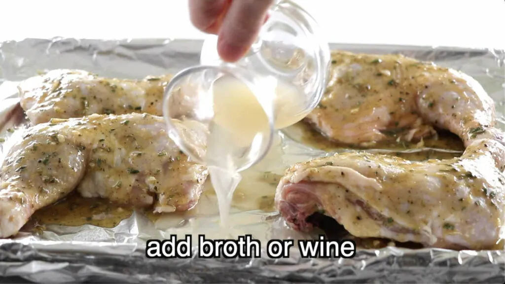 Pouring broth into a pan with chicken quarters.