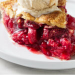 A slice of strawberry rhubarb pie on a plate.