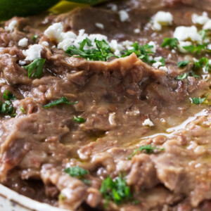 A dish filled with refried beans.