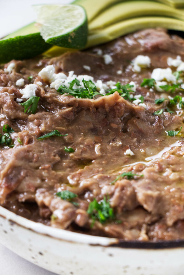 A dish filled with refried beans.