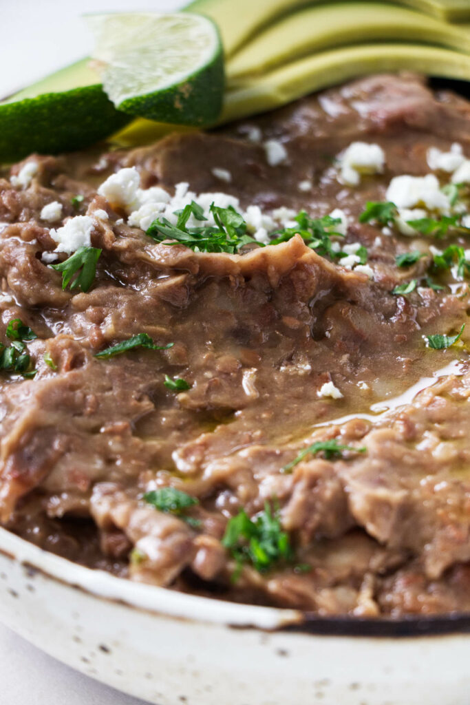 A dish filled with refried beans.