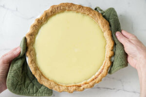 Placing the pie on the counter to cool.