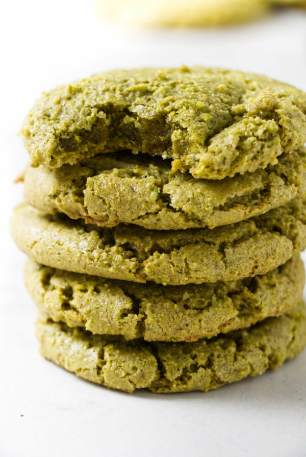 Five pistachio cookies stacked on each other.