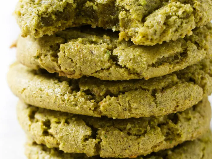 Five pistachio cookies stacked on each other.