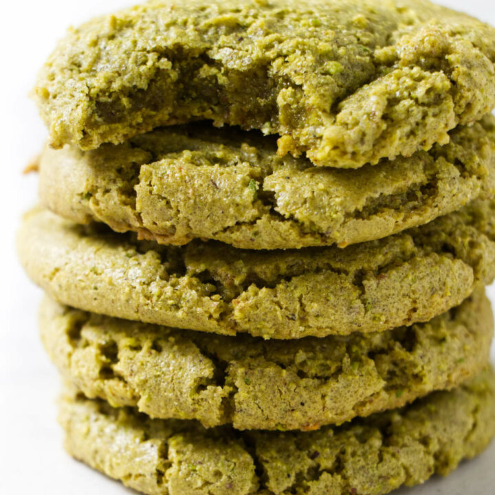 Five pistachio cookies stacked on each other.