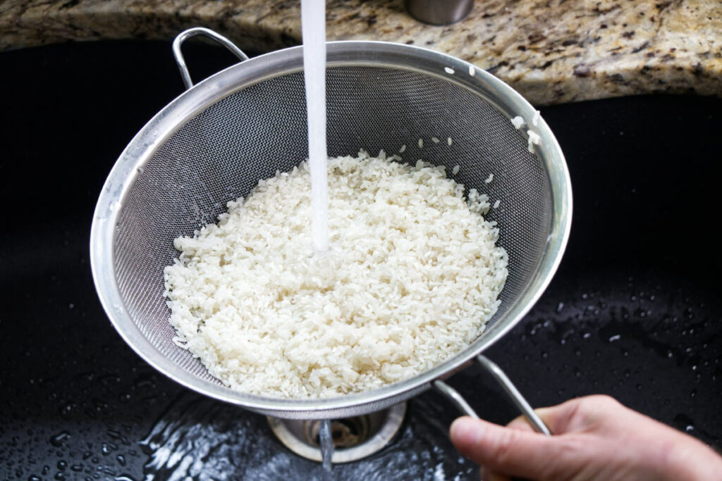Rinsing Japanese rice in cold water.