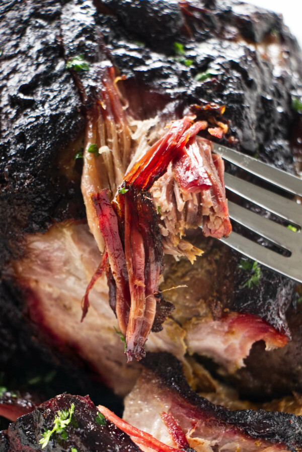 Shredding pulled pork to show the smoke ring.