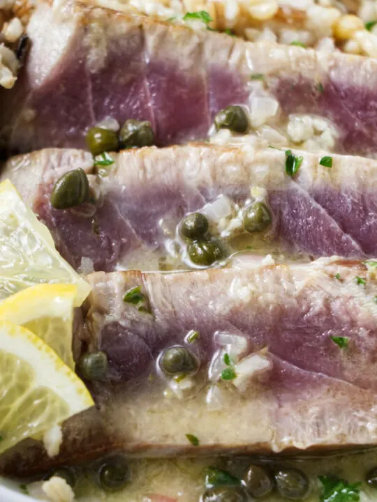 Slices of tuna steak with lemon caper sauce.