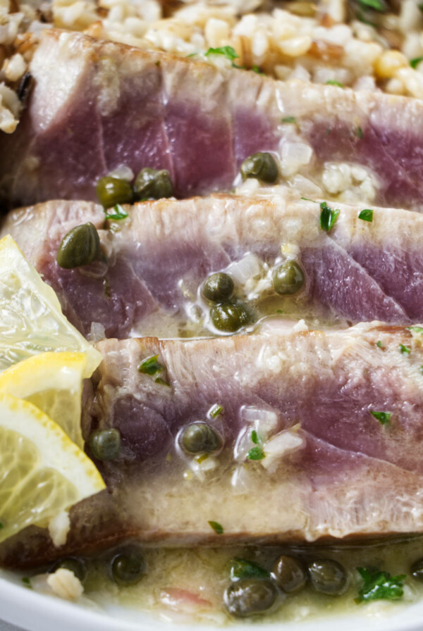 Slices of tuna steak with lemon caper sauce.