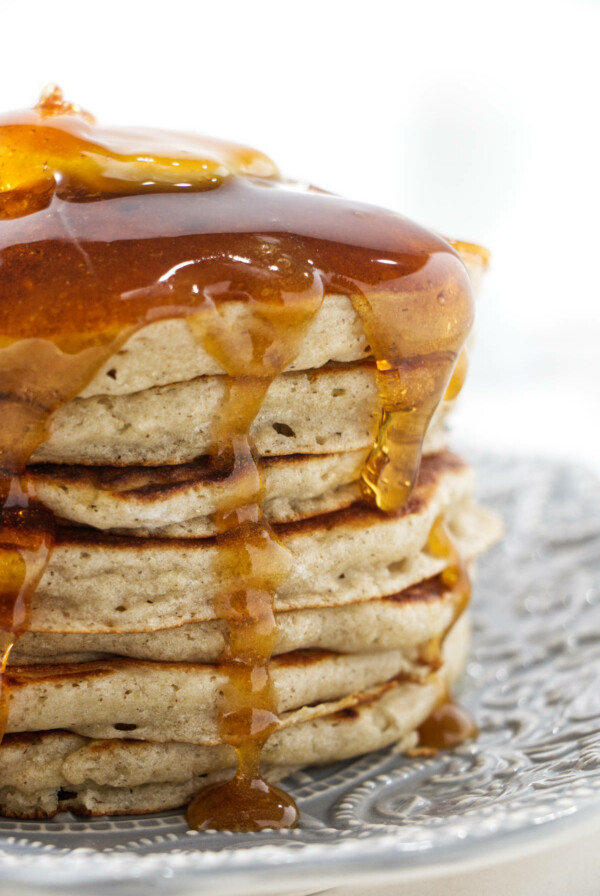 Syrup running down a stack of pancakes.