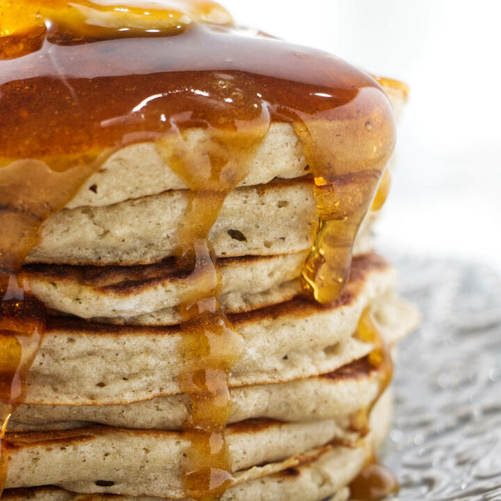 Syrup running down a stack of pancakes.