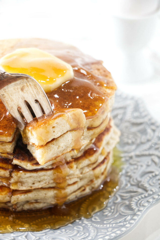 A fork stabbing a bite of a pancake.