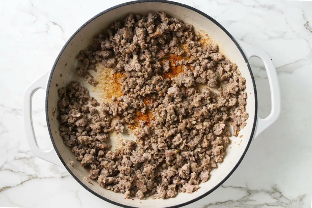 Browned sausage in a skillet.