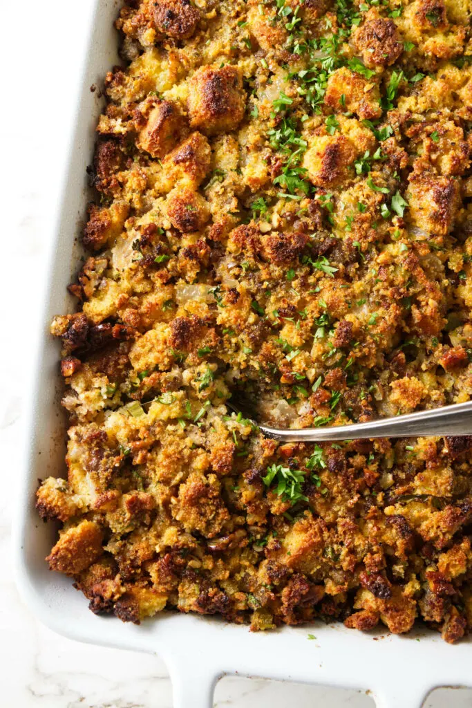 A casserole dish with baked cornbread stuffing.