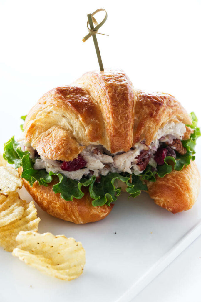 A chicken salad sandwich on a plate.