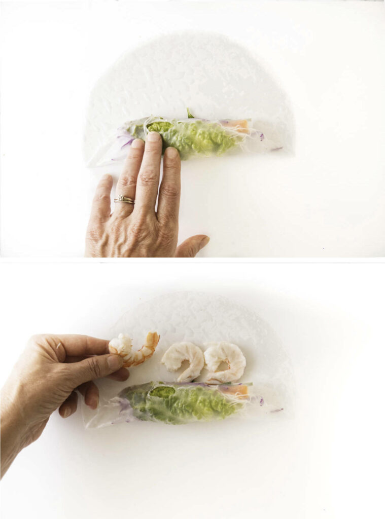Rolling vegetables and shrimp inside a rice paper wrapper.